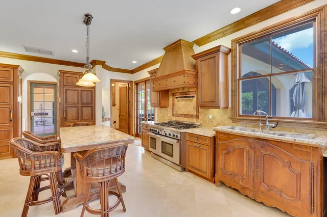 a kitchen with stainless steel appliances granite countertop a sink and cabinets