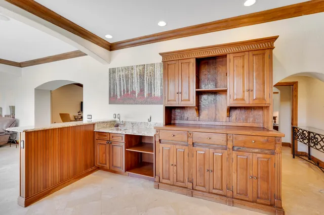 a large kitchen with a table and chairs