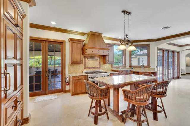 a kitchen with stainless steel appliances granite countertop a stove and a sink