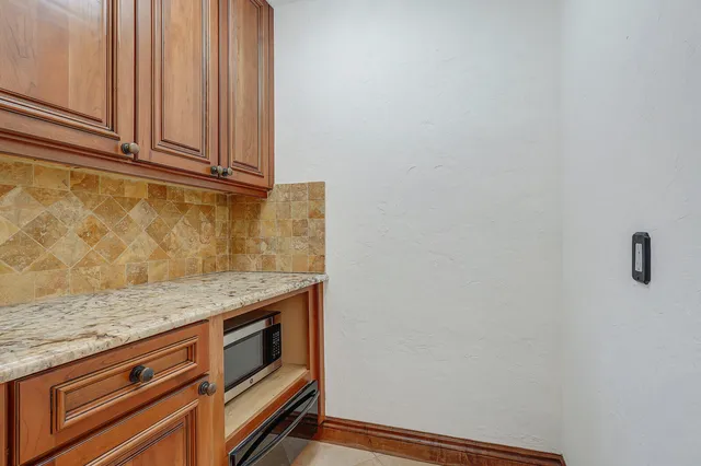 a bathroom with a granite countertop sink a toilet and a mirror
