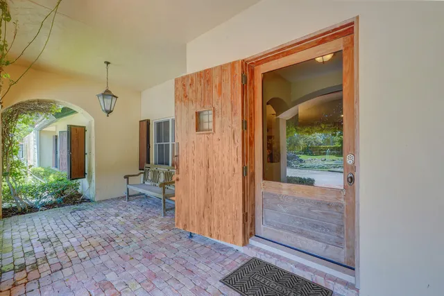 a view of a hallway with wooden shelves