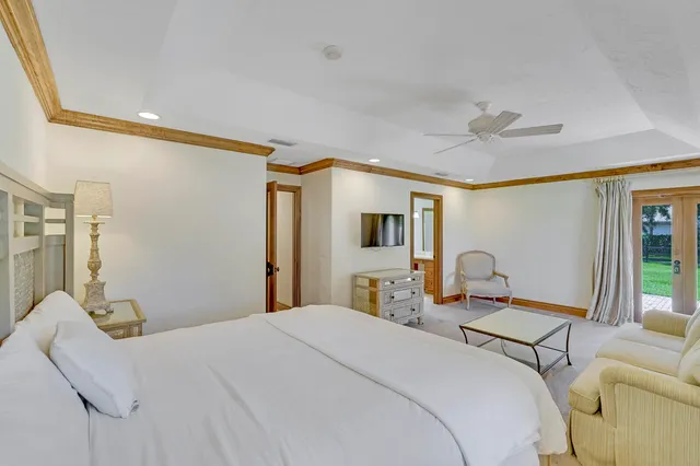 a spacious bedroom with a bed and a chandelier