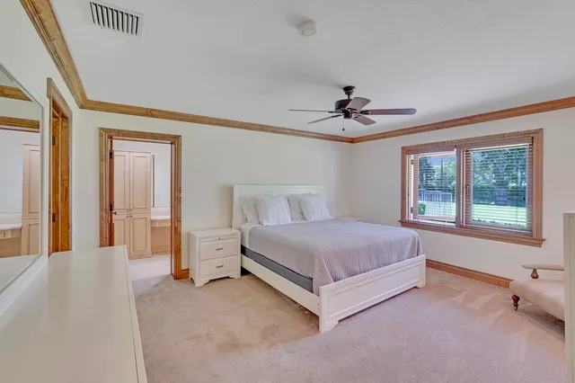 a bathroom with a double vanity sink toilet and a mirror