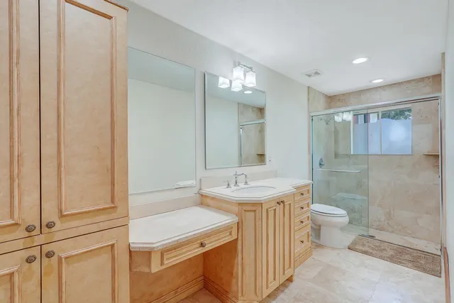 a spacious bedroom with a large bed and a large window