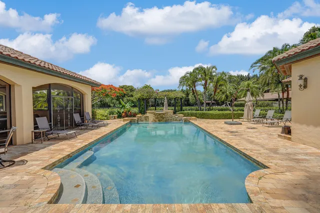 a front view of a house with swimming pool having outdoor seating