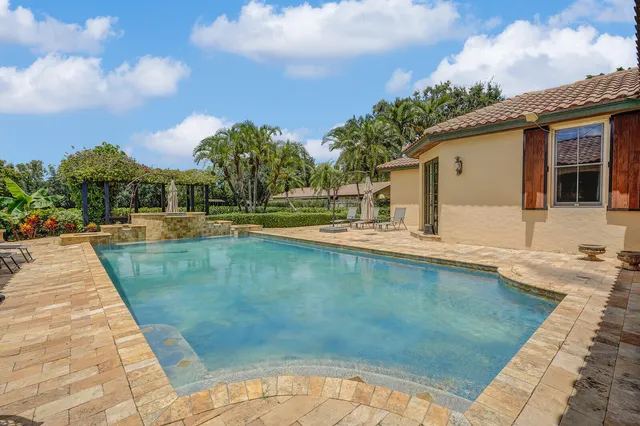 a view of a patio with table and chairs under an umbrella