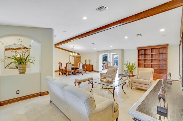 a view of a dining room with furniture and a chandelier
