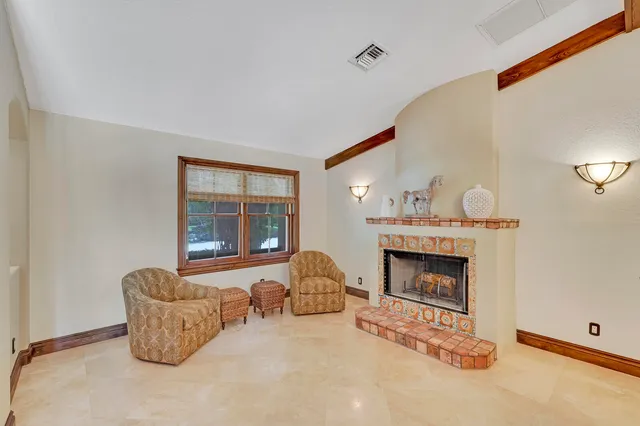 a living room with furniture a ceiling fan and a rug