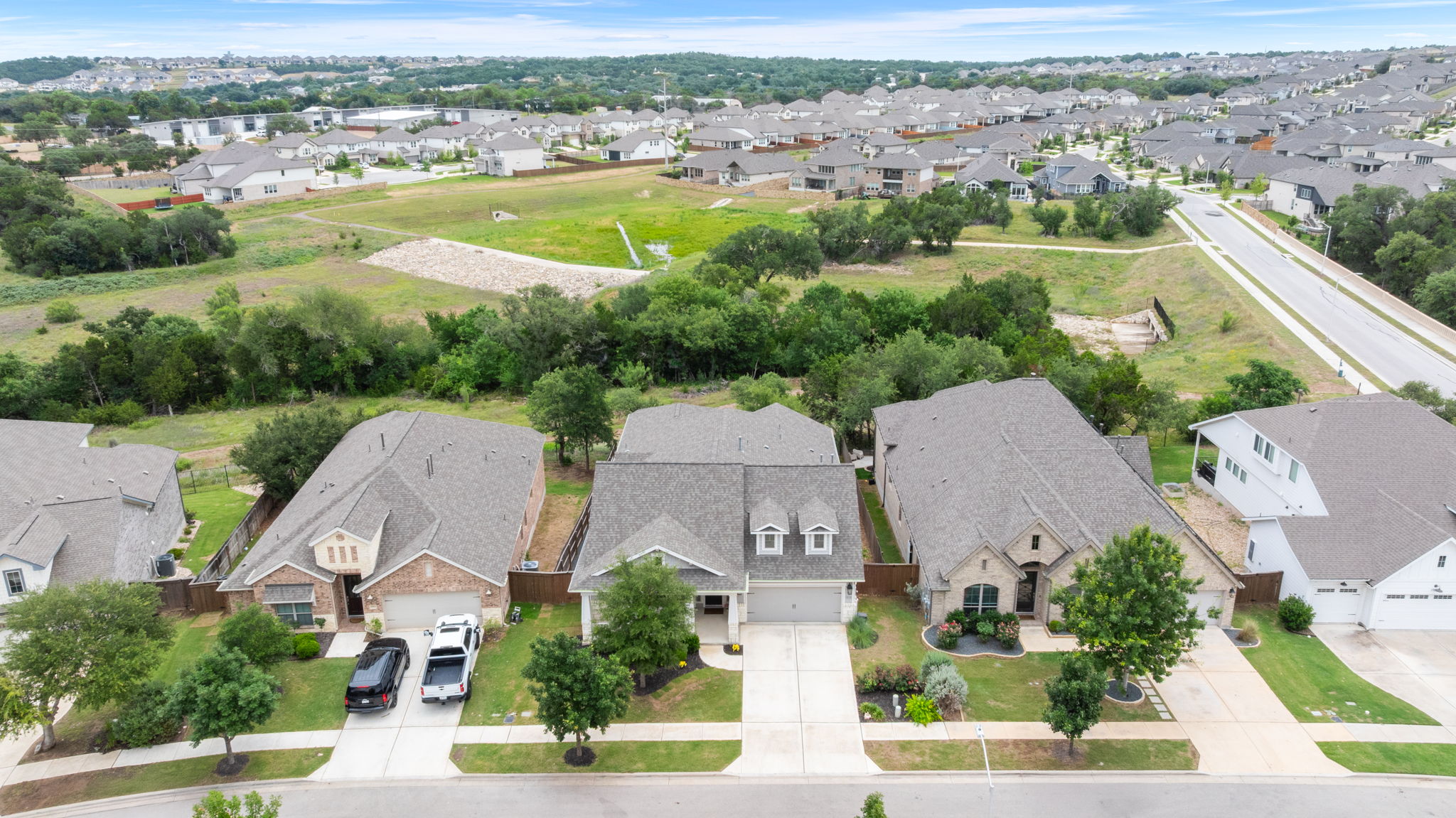 1908 Woolsey Way Leander, TX 78641 - Photo 30 of 36 The home is beautifully positioned against a natural greenbelt backdrop, creating a peaceful and private setting.