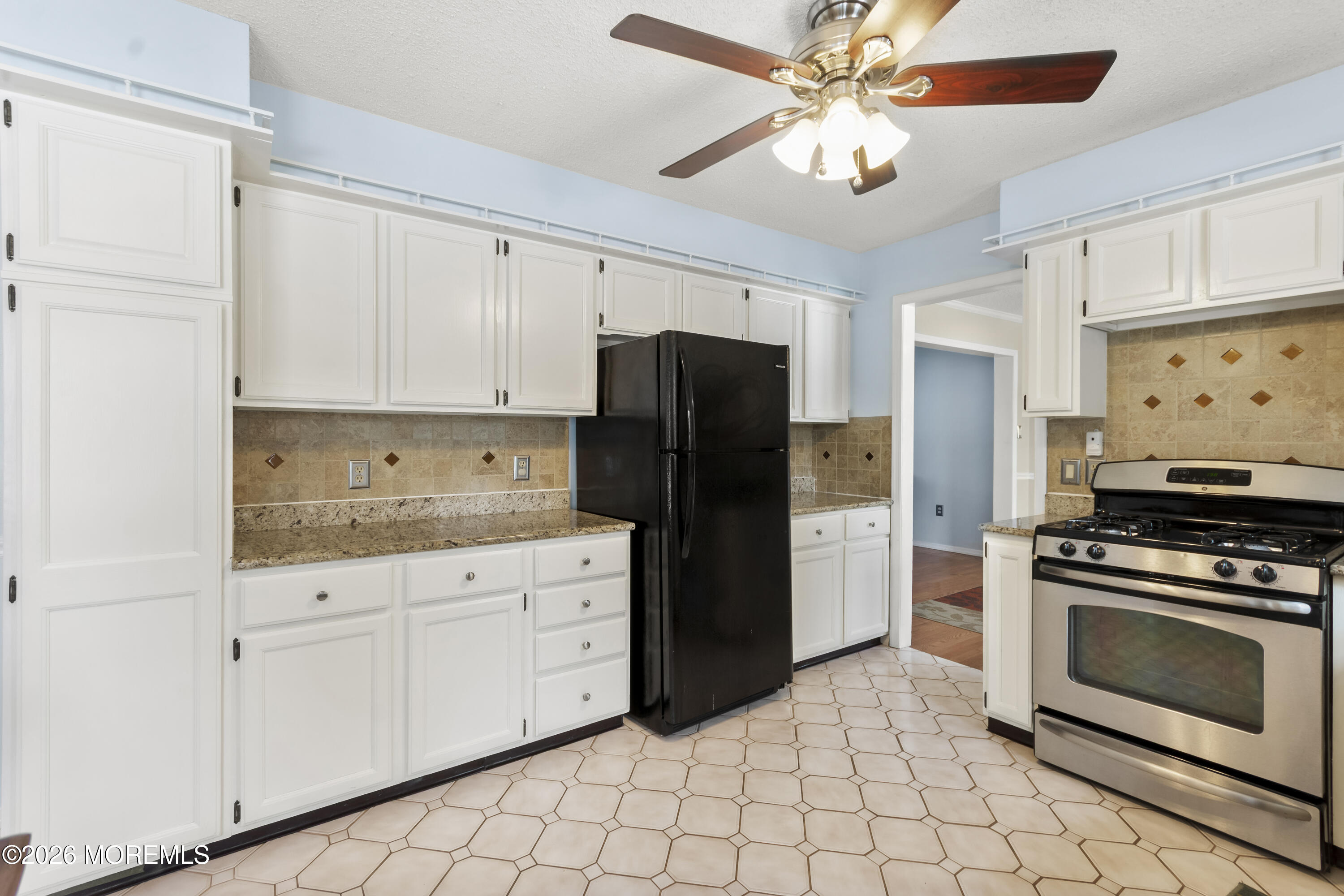 46 Hickory Hill Road Jackson, NJ 08527 - Photo 11 of 33 a kitchen with granite countertop a stove a refrigerator and a sink