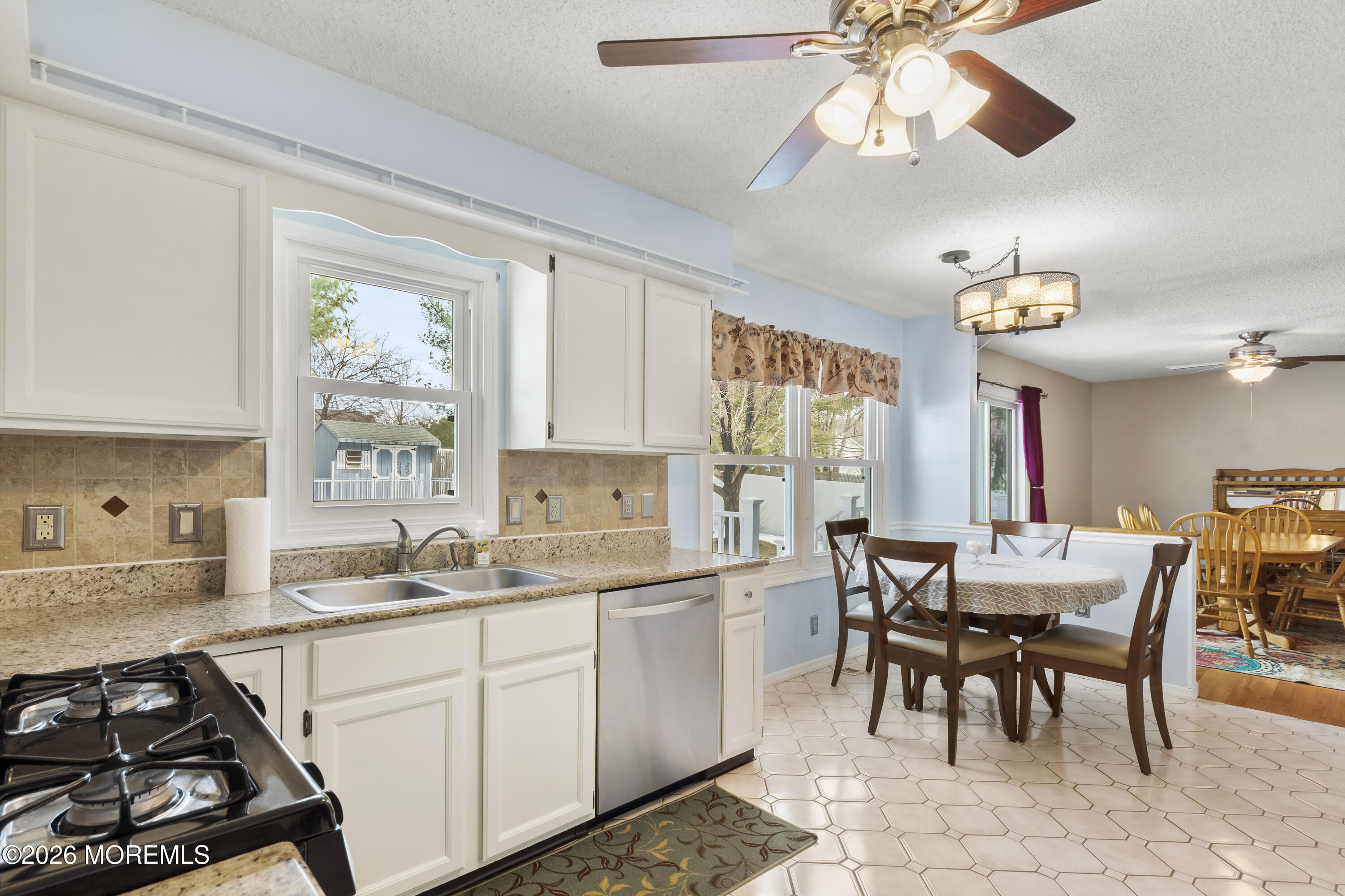 46 Hickory Hill Road Jackson, NJ 08527 - Photo 12 of 33 a kitchen with a table chairs and a stove