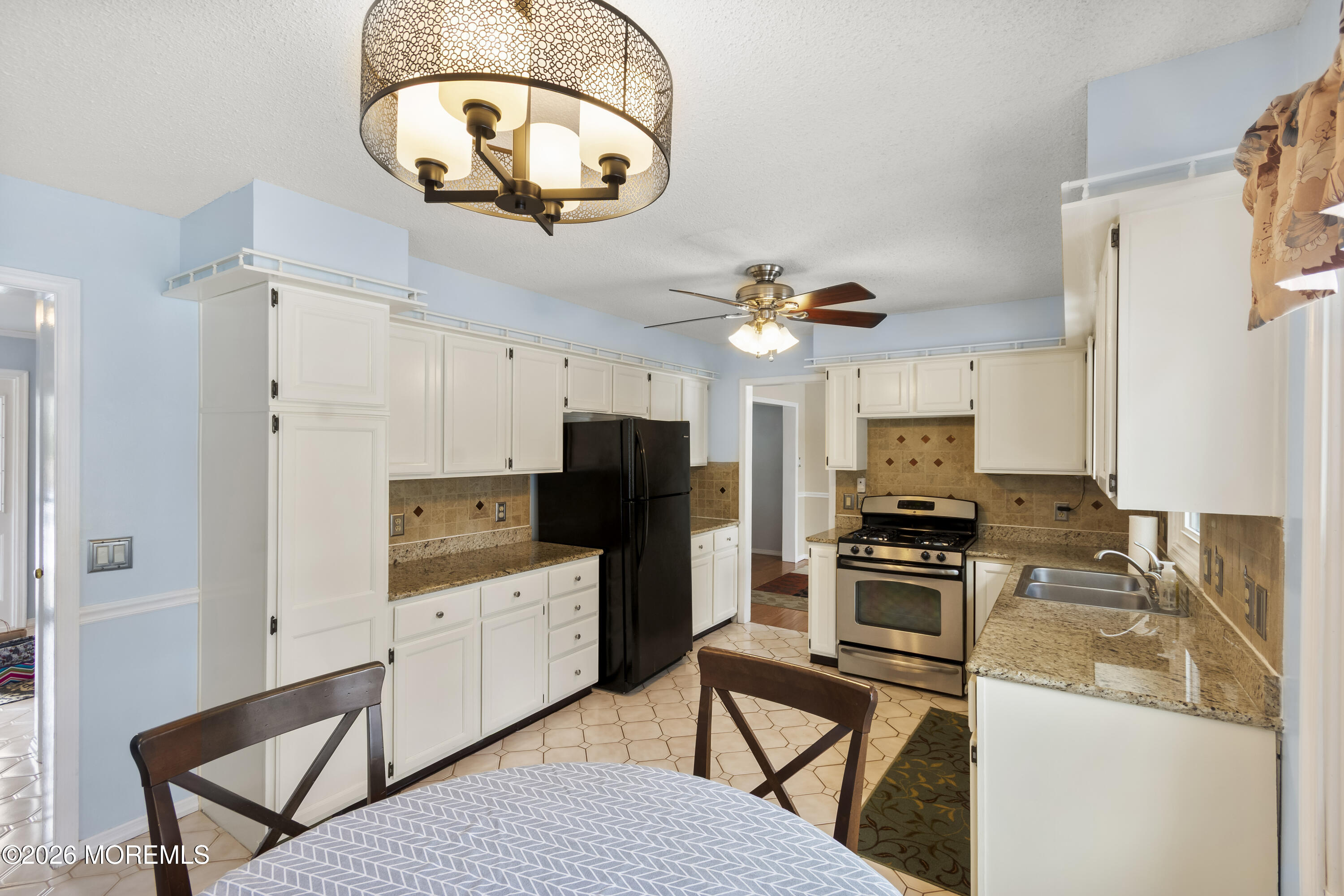 46 Hickory Hill Road Jackson, NJ 08527 - Photo 14 of 33 a kitchen with stainless steel appliances a stove a refrigerator and a sink