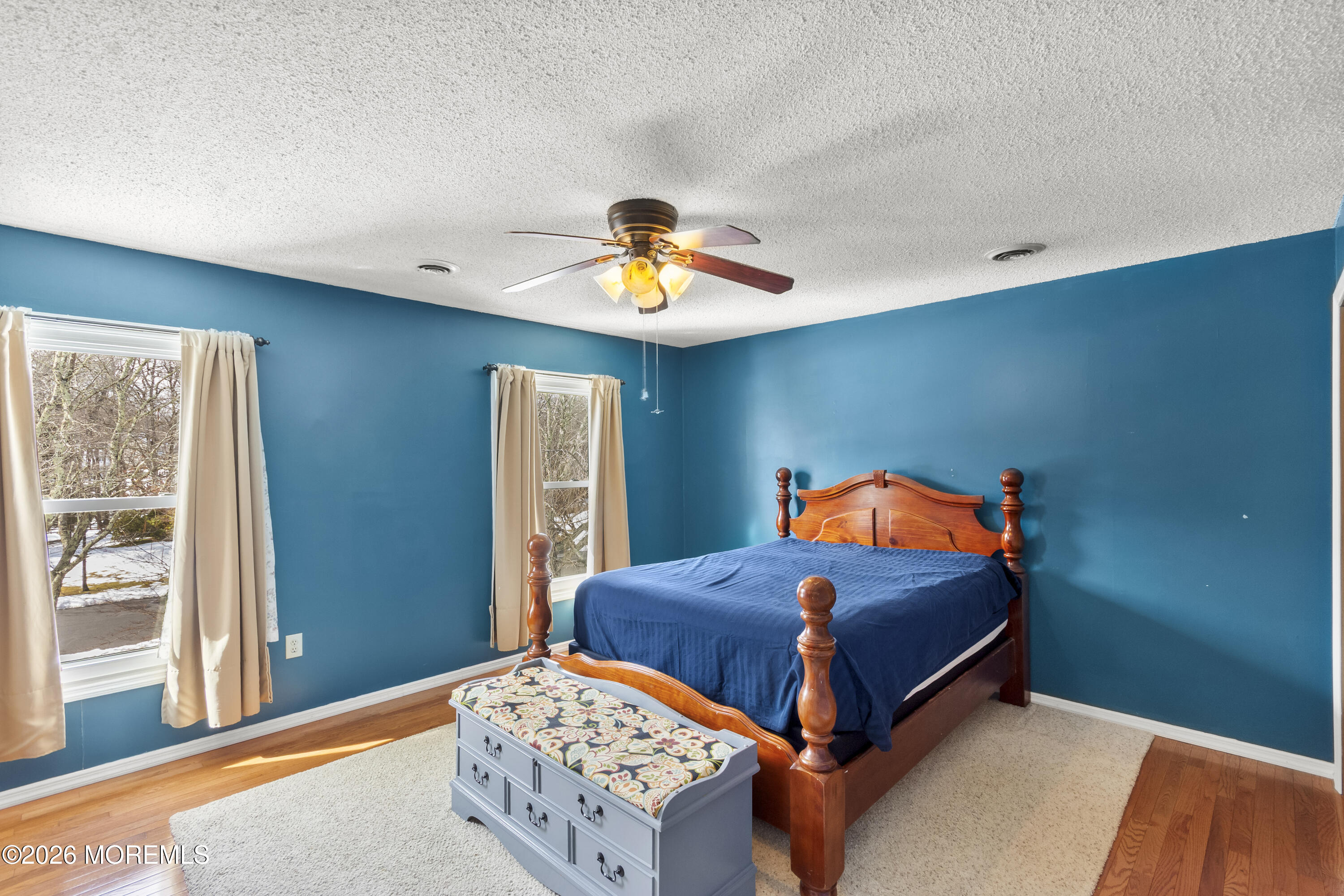 46 Hickory Hill Road Jackson, NJ 08527 - Photo 19 of 33 a bedroom with a bed and a chandelier