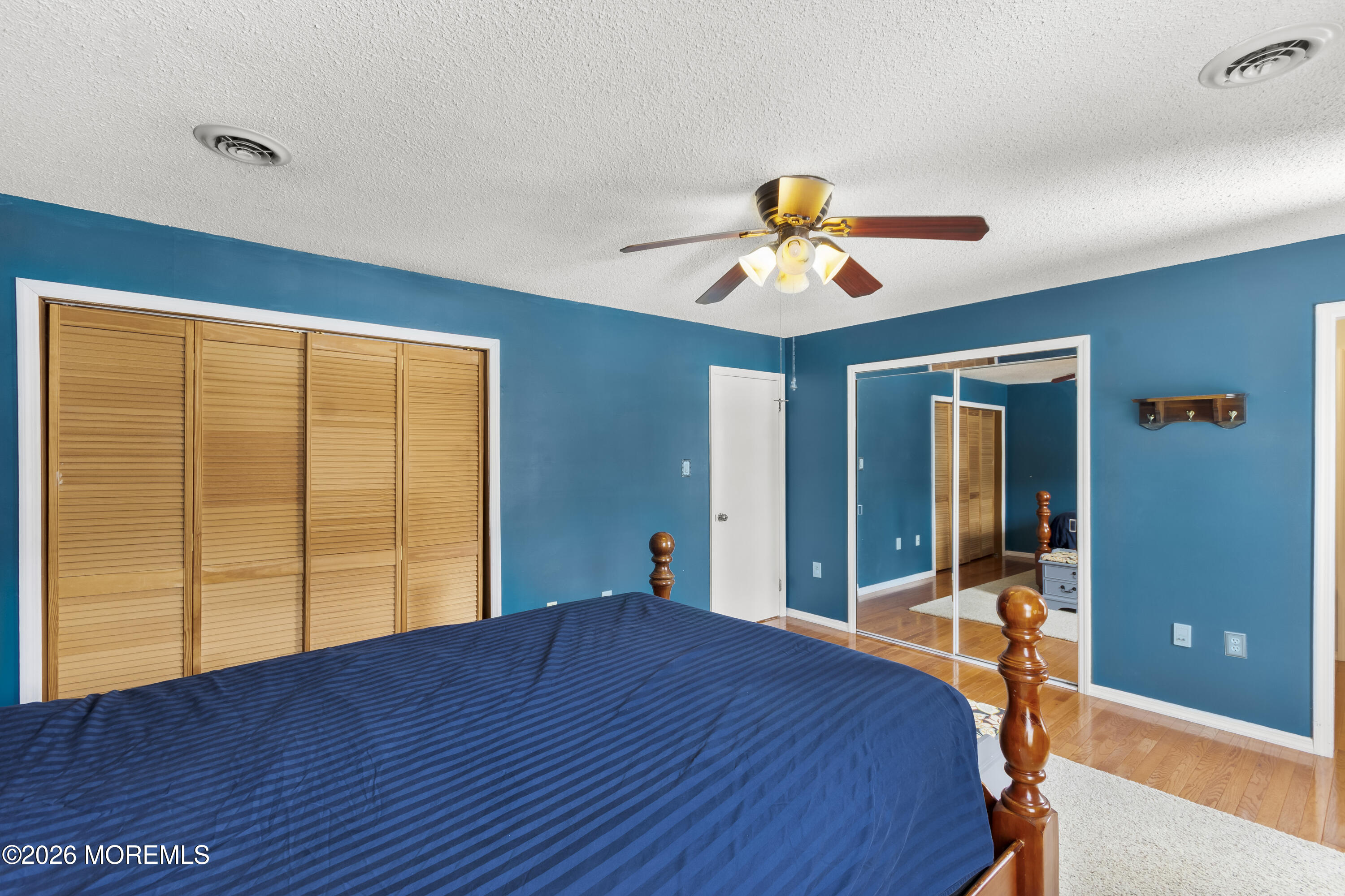 46 Hickory Hill Road Jackson, NJ 08527 - Photo 20 of 33 a bedroom with a bed and a chandelier