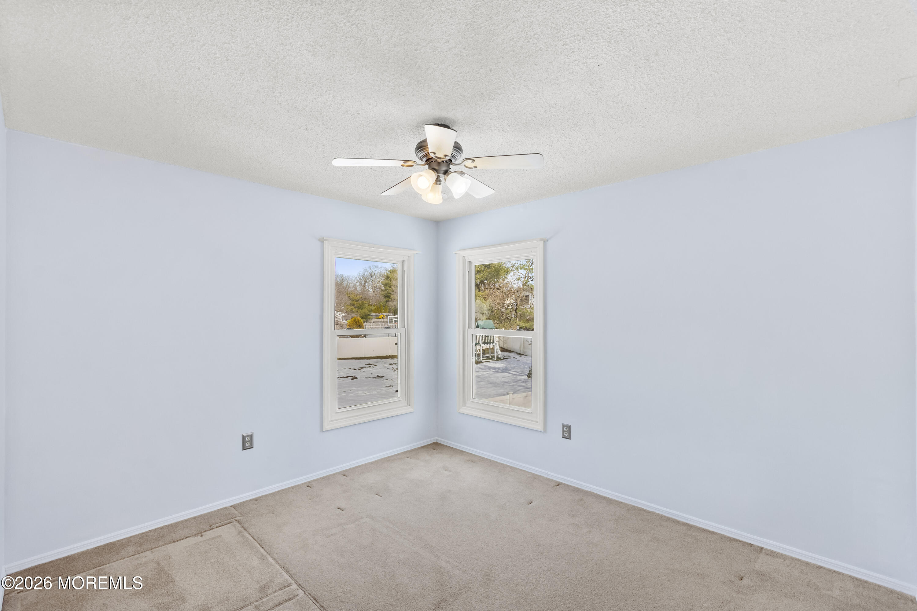 46 Hickory Hill Road Jackson, NJ 08527 - Photo 23 of 33 an empty room with windows and ceiling fan