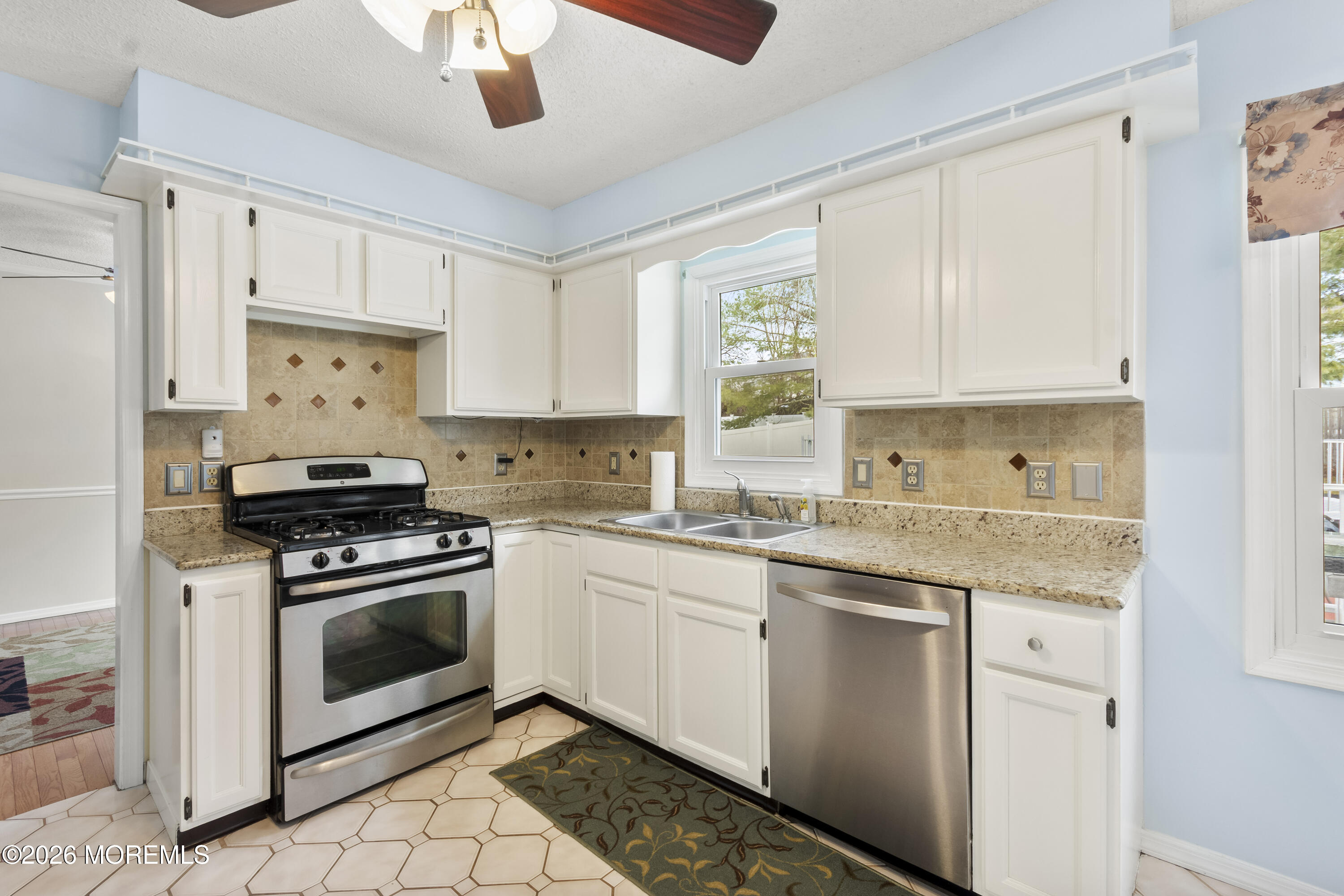 46 Hickory Hill Road Jackson, NJ 08527 - Photo 10 of 33 a kitchen with stainless steel appliances granite countertop a stove a sink and a microwave
