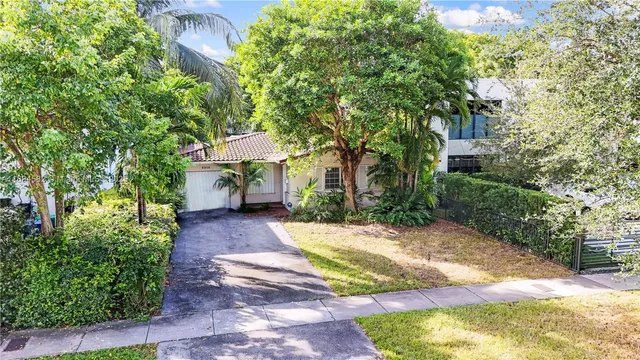 a view of a backyard with plants and a patio