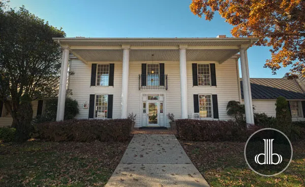 a front view of a house with garden