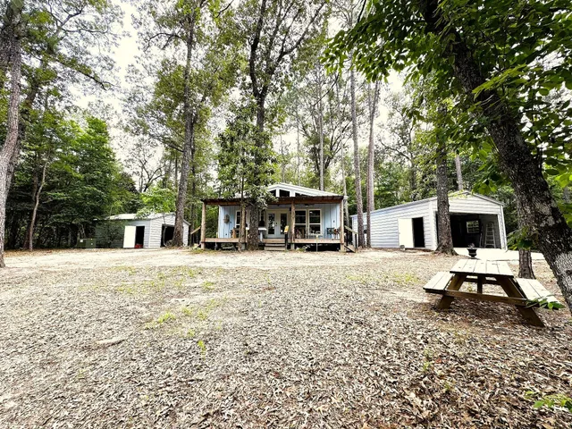 a view of a house with backyard and sitting area