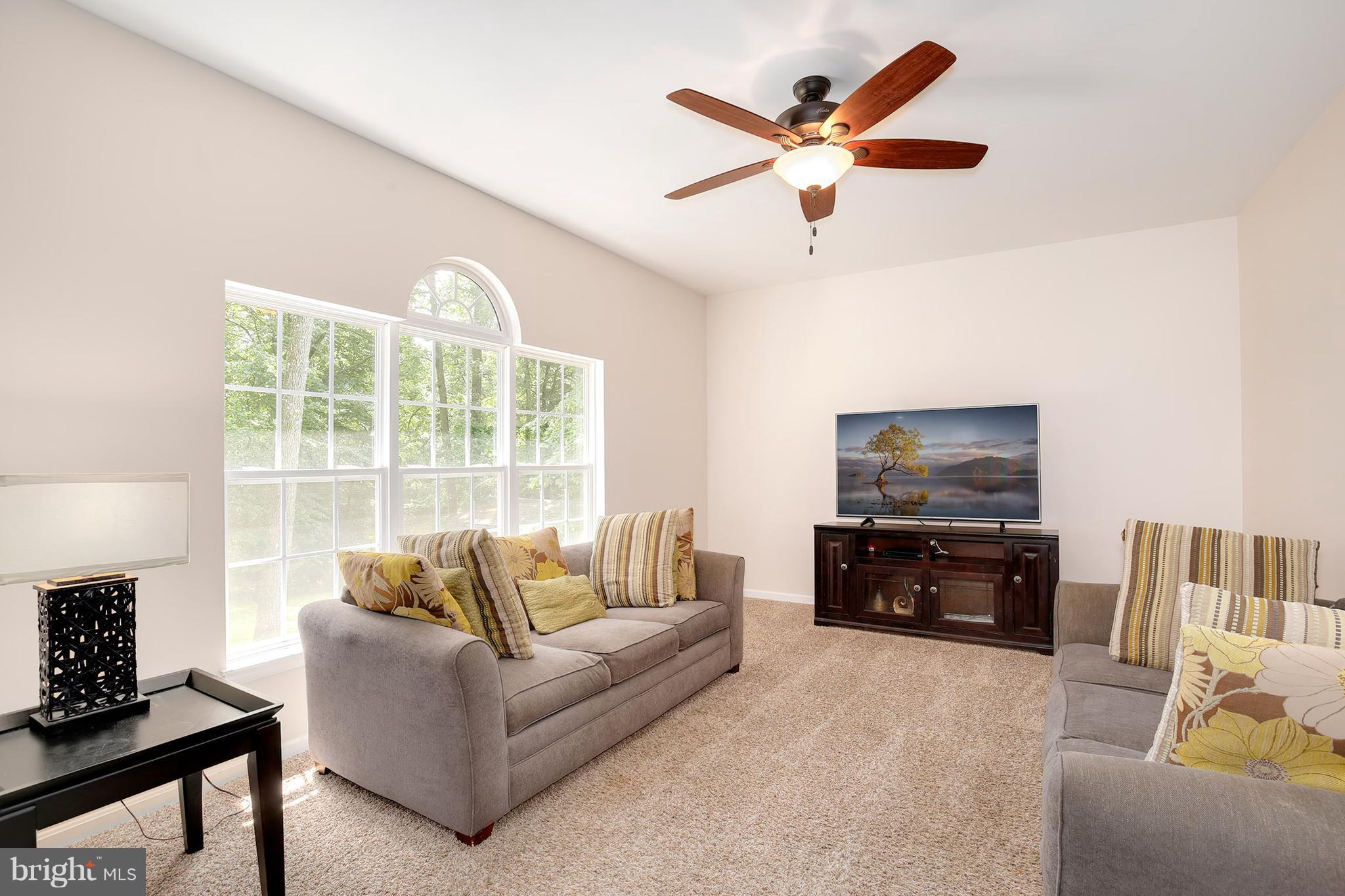 3 Brooks Court Baltimore, MD 21244 - Photo 11 of 30 a living room with furniture and a flat screen tv with wooden floor