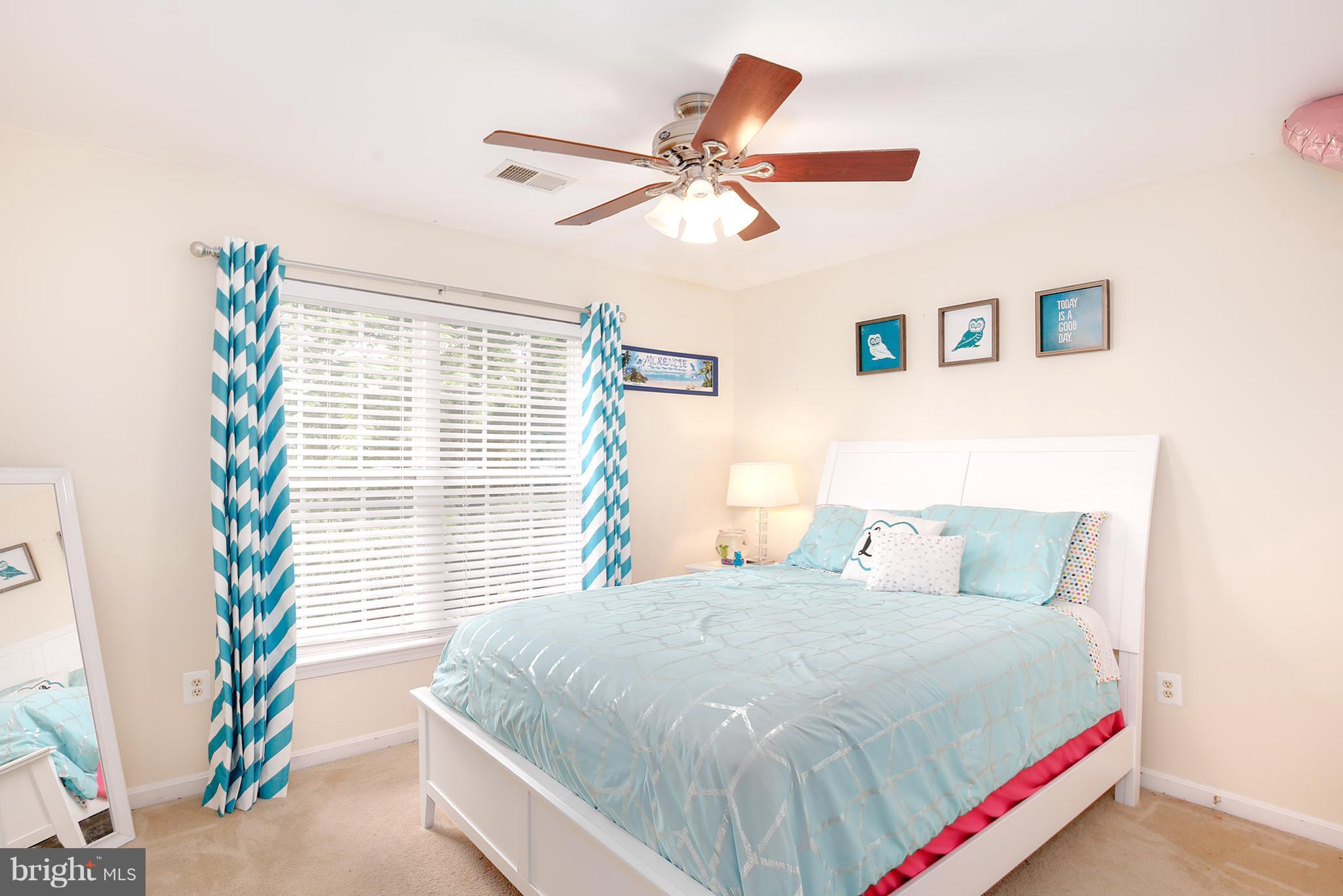 3 Brooks Court Baltimore, MD 21244 - Photo 13 of 30 a bed sitting in a bedroom next to a window