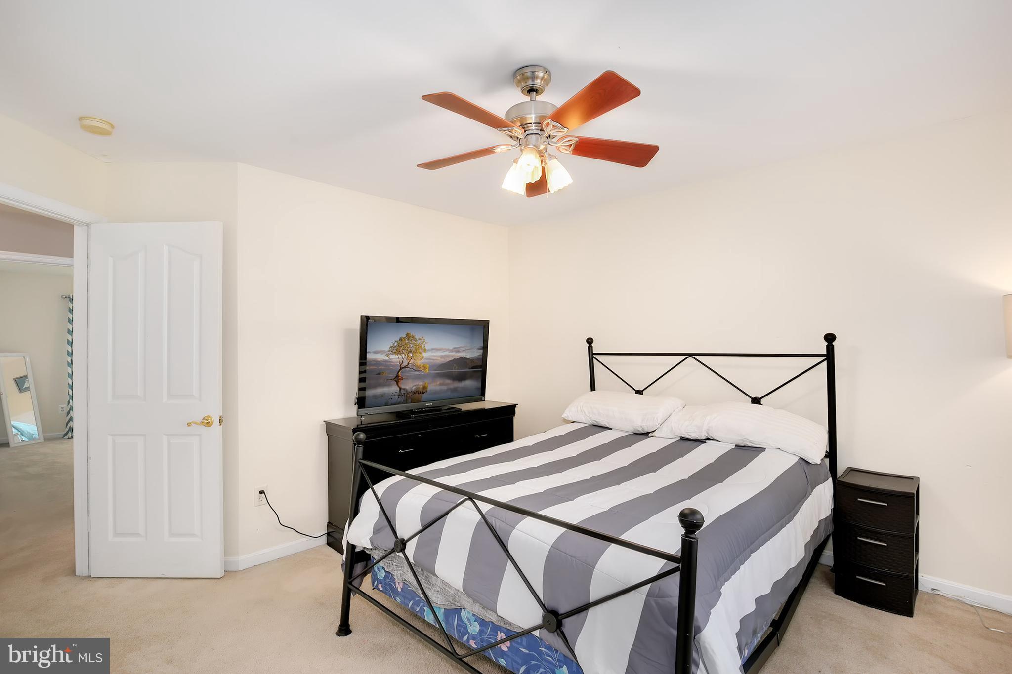 3 Brooks Court Baltimore, MD 21244 - Photo 14 of 30 a bedroom with a bed and a chandelier