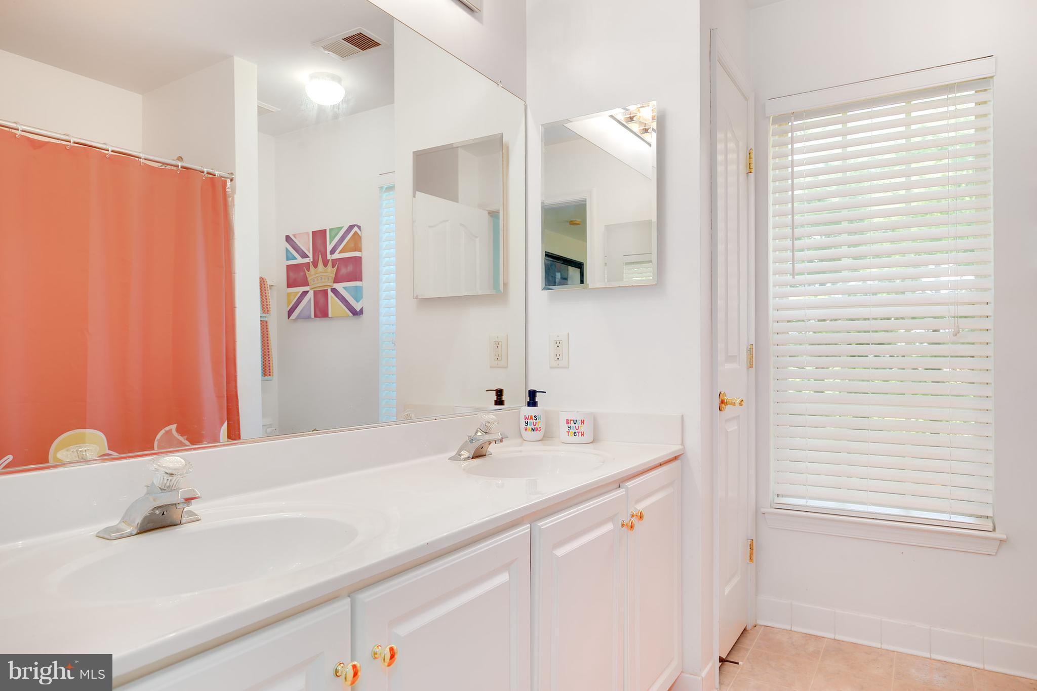 3 Brooks Court Baltimore, MD 21244 - Photo 15 of 30 a bathroom with a sink and a mirror