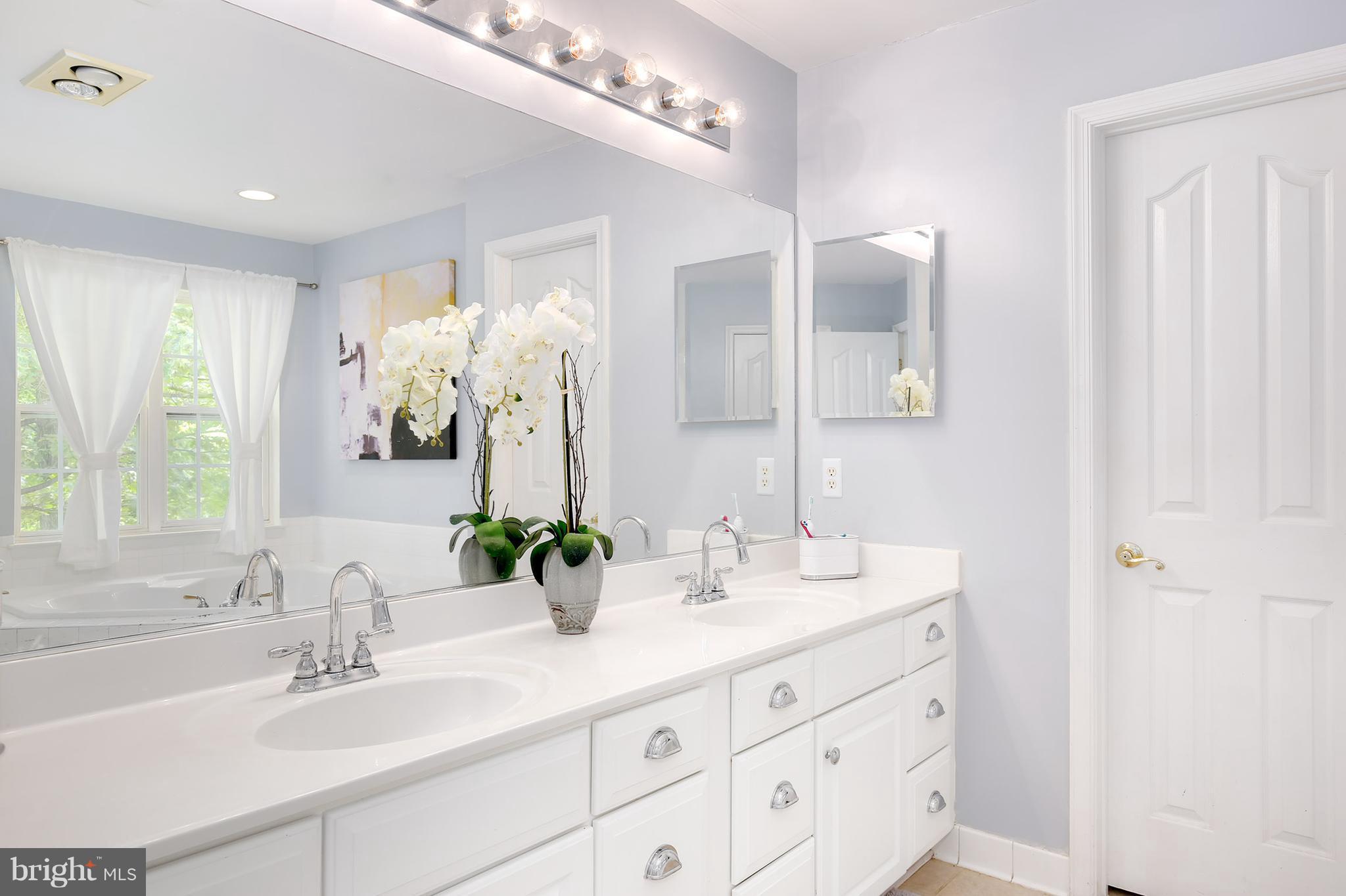 3 Brooks Court Baltimore, MD 21244 - Photo 19 of 30 a bathroom with a double vanity sink and a mirror