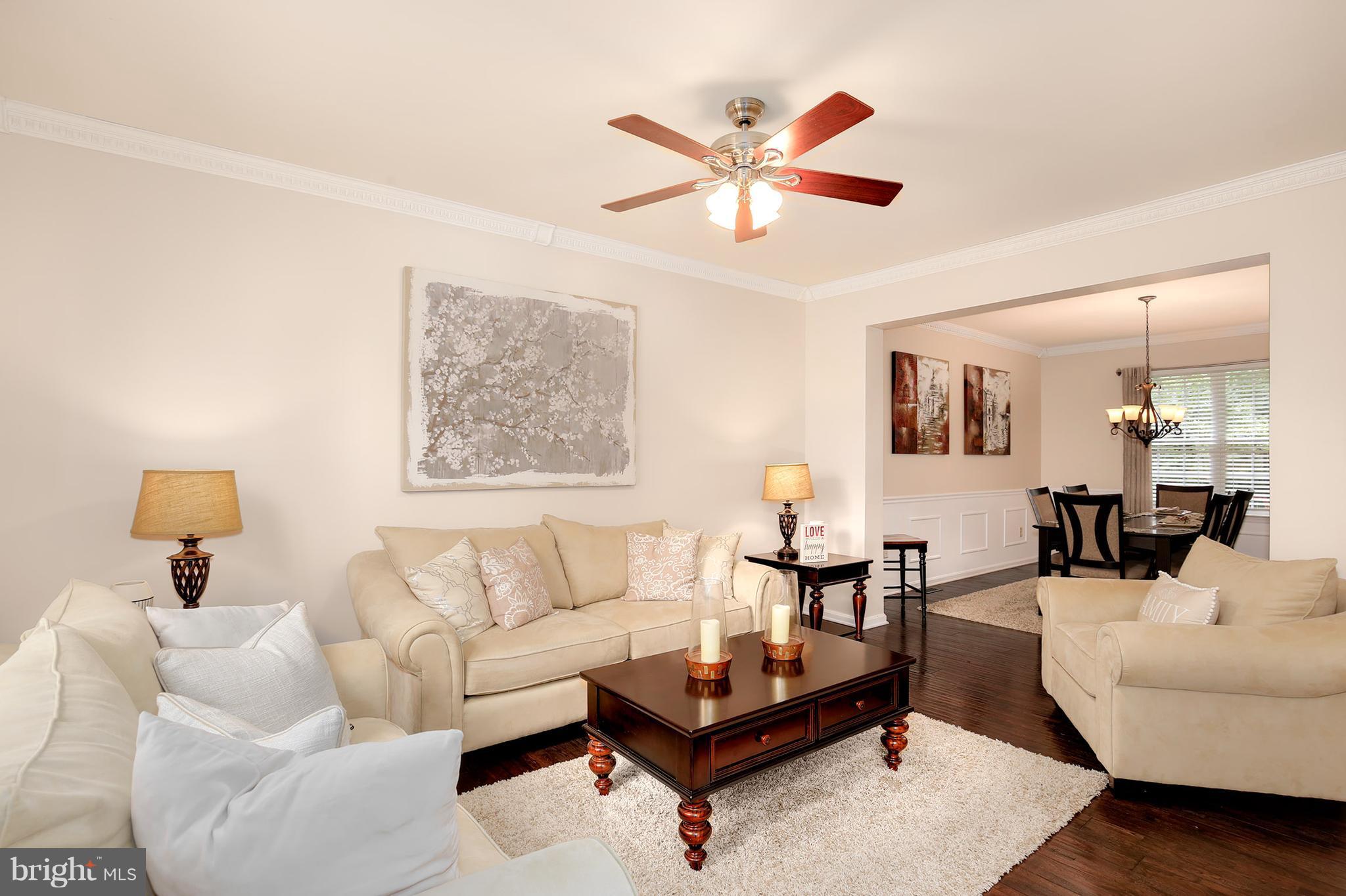 3 Brooks Court Baltimore, MD 21244 - Photo 5 of 30 a living room with furniture and a painting on the wall