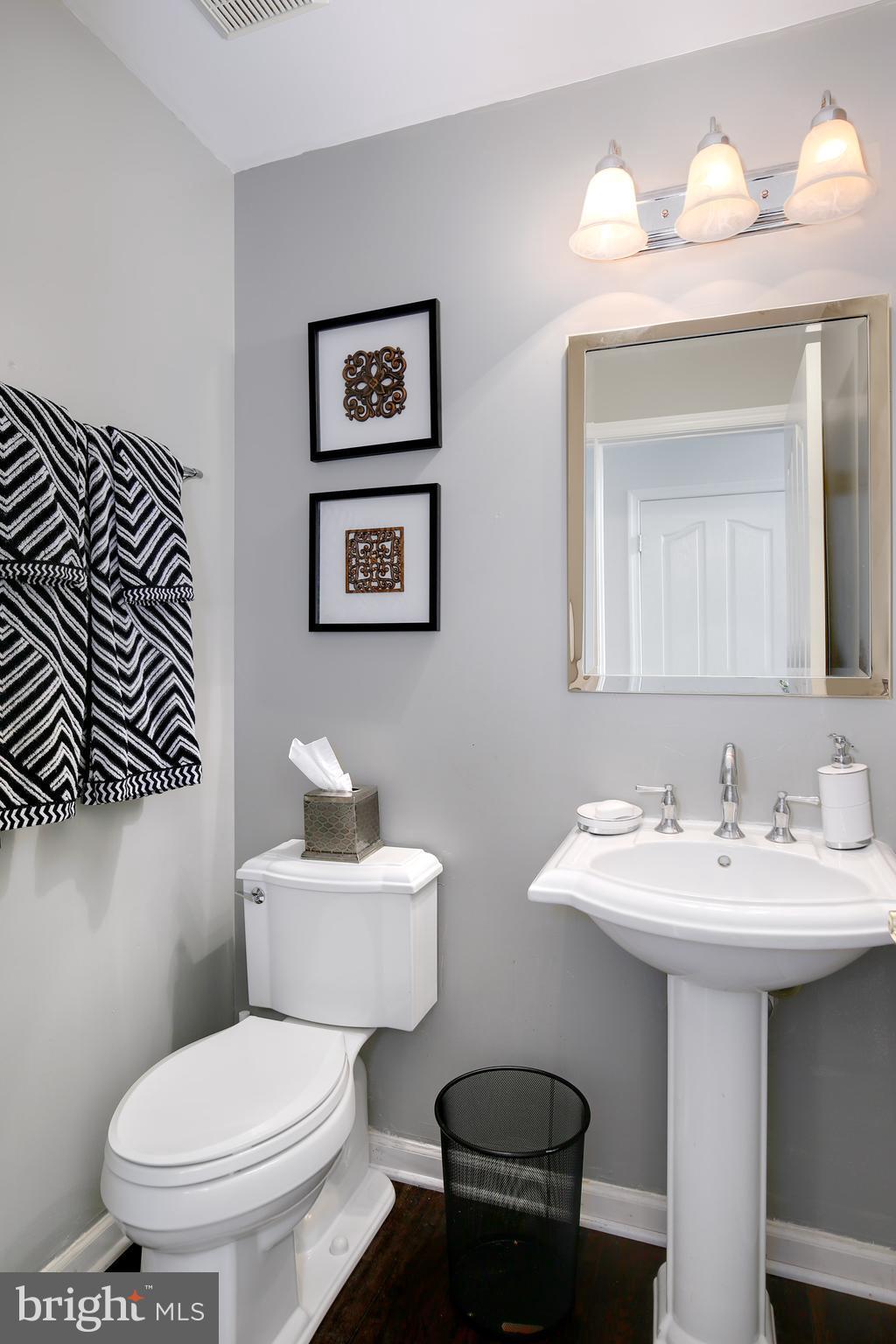 3 Brooks Court Baltimore, MD 21244 - Photo 7 of 30 a bathroom with a toilet a sink and mirror