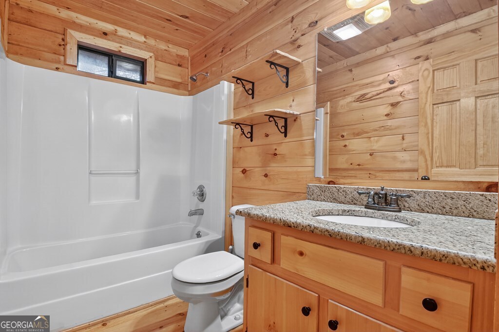 63 Posey Road Blue Ridge, GA 30513 - Photo 11 of 21 a bathroom with a granite countertop sink toilet and shower