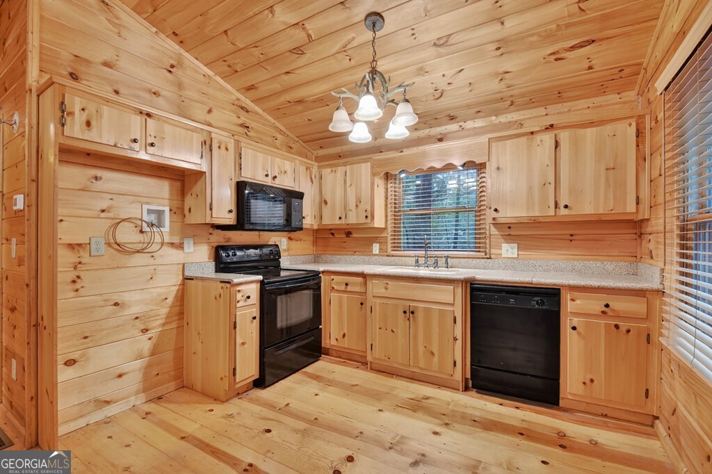 63 Posey Road Blue Ridge, GA 30513 - Photo 15 of 21 a kitchen with stainless steel appliances granite countertop a stove sink microwave and cabinets