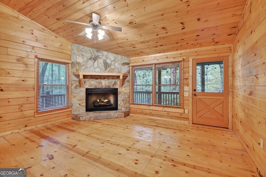 63 Posey Road Blue Ridge, GA 30513 - Photo 3 of 21 a view of an empty room with a fireplace and a window