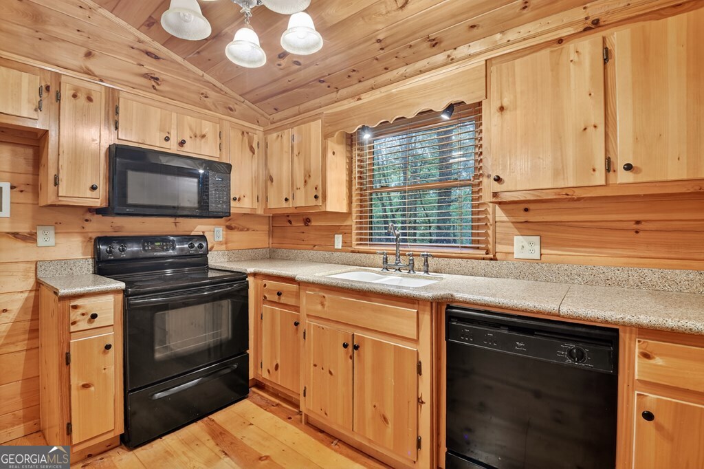 63 Posey Road Blue Ridge, GA 30513 - Photo 5 of 21 a kitchen with stainless steel appliances granite countertop a stove a sink and a microwave