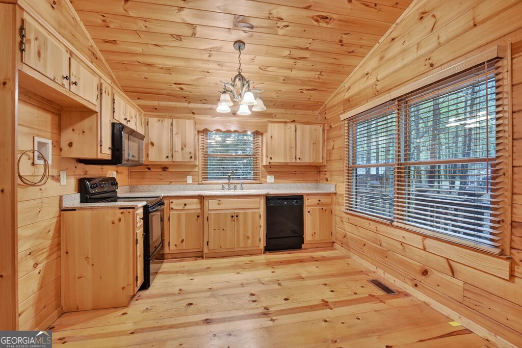 63 Posey Road Blue Ridge, GA 30513 - Photo 7 of 21 a kitchen with stainless steel appliances granite countertop a stove a sink and dishwasher