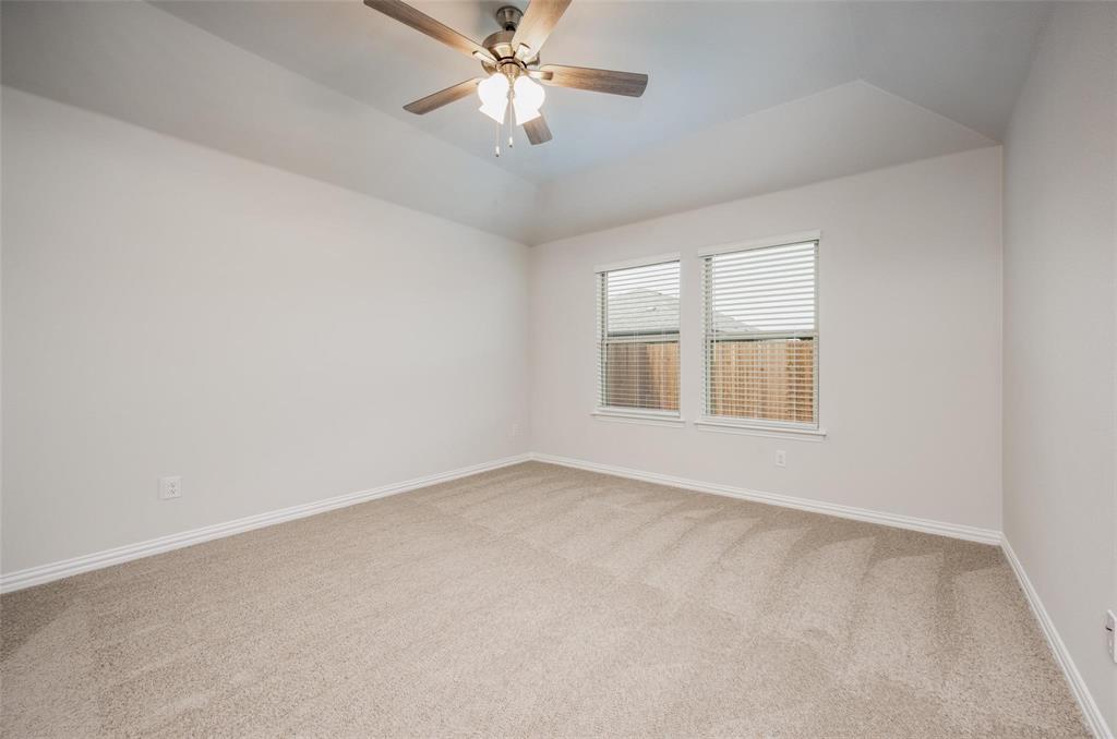 5113 Unity Drive Denton, TX 76207 - Photo 16 of 22 an empty room with windows and fan