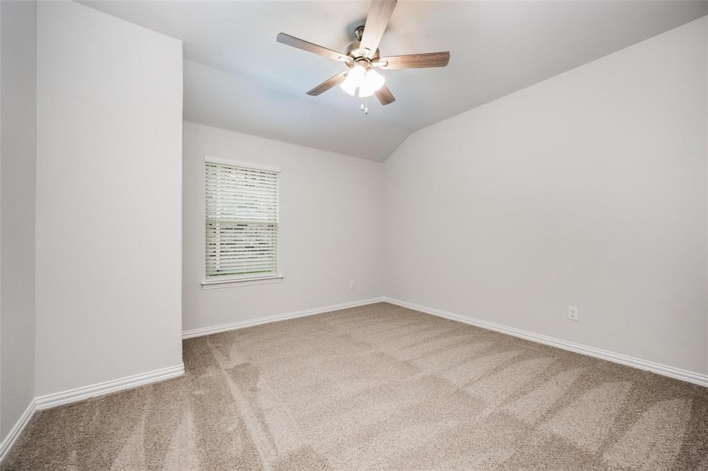 5113 Unity Drive Denton, TX 76207 - Photo 19 of 22 an empty room with windows and fan