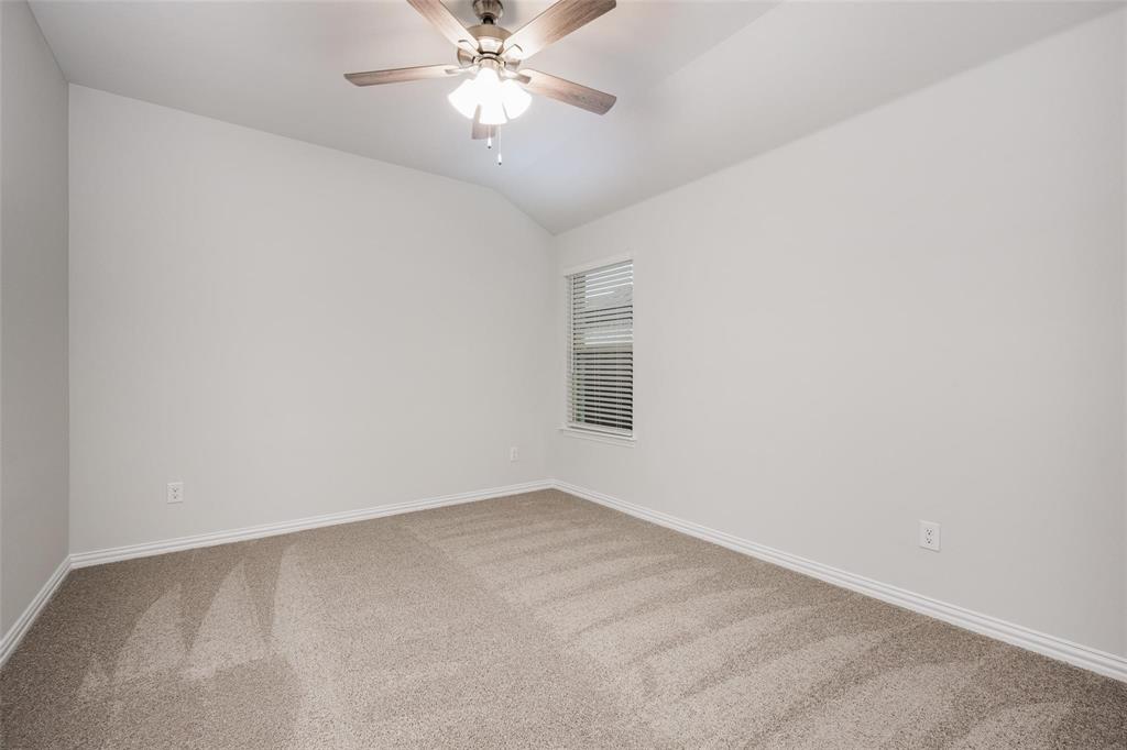 5113 Unity Drive Denton, TX 76207 - Photo 20 of 22 an empty room with a window and a fan