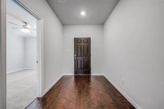 a view of hallway with wooden floor