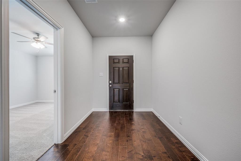 5113 Unity Drive Denton, TX 76207 - Photo 3 of 22 a view of hallway with wooden floor