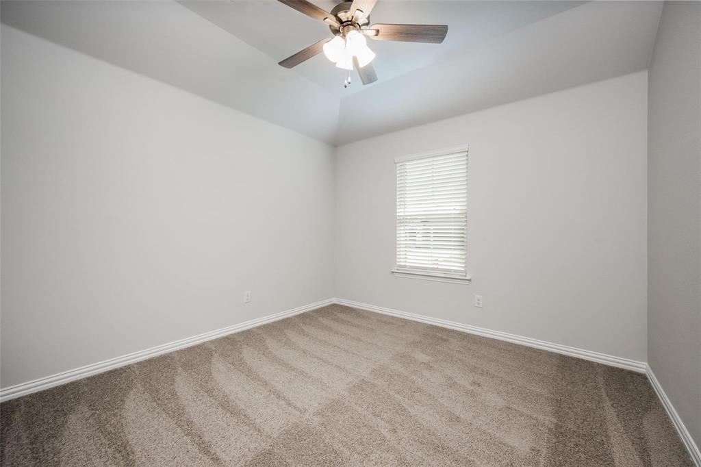 5113 Unity Drive Denton, TX 76207 - Photo 5 of 22 an empty room with a window and a fan