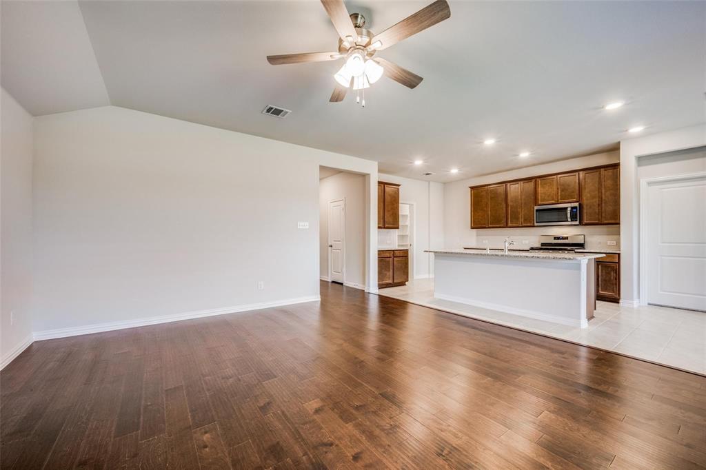 5113 Unity Drive Denton, TX 76207 - Photo 10 of 22 a view of kitchen with refrigerator stove microwave and cabinets