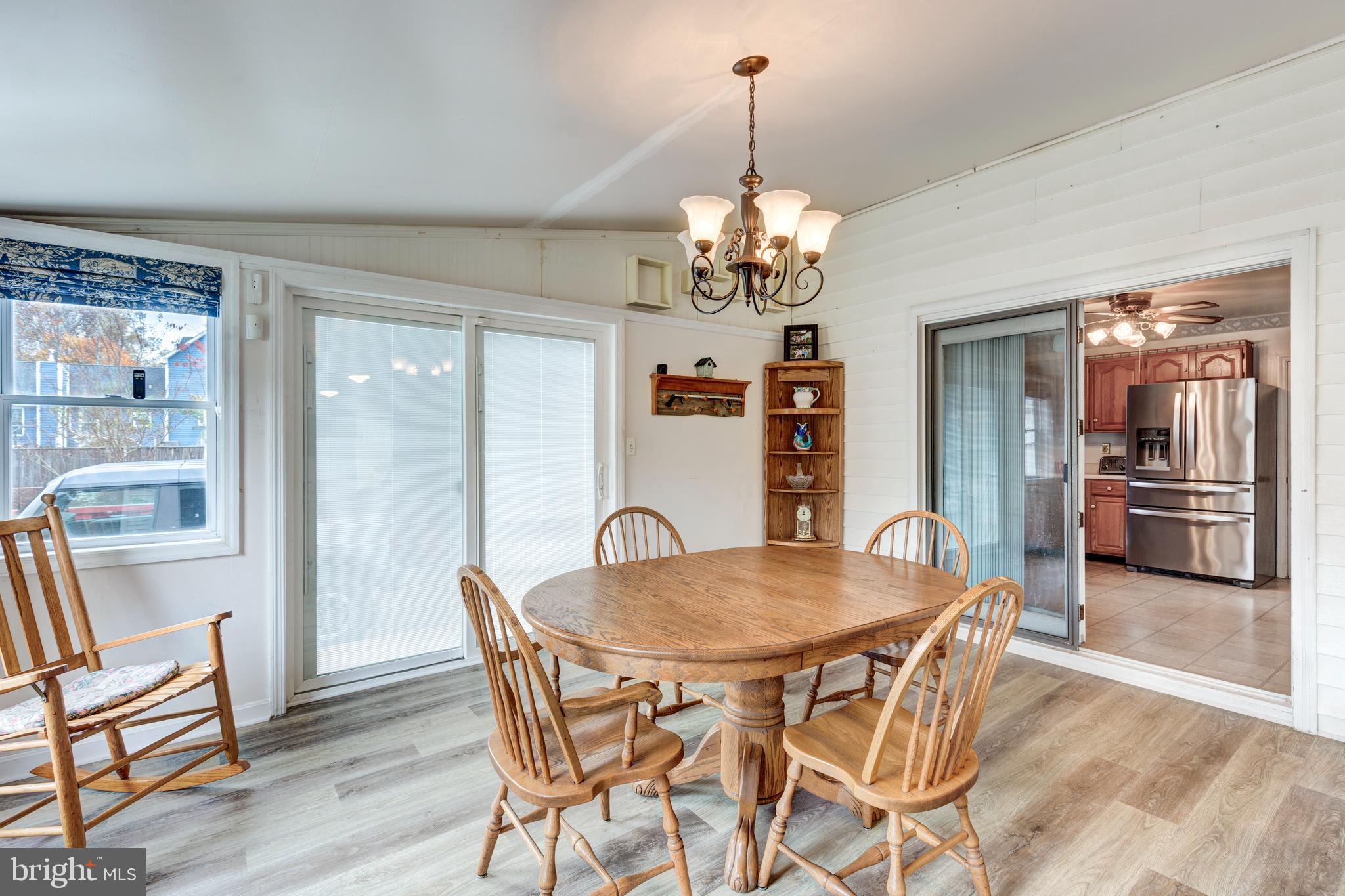 3402 Offutt Road Randallstown, MD 21133 - Photo 13 of 63 a view of a dining room with furniture wooden floor and chandelier