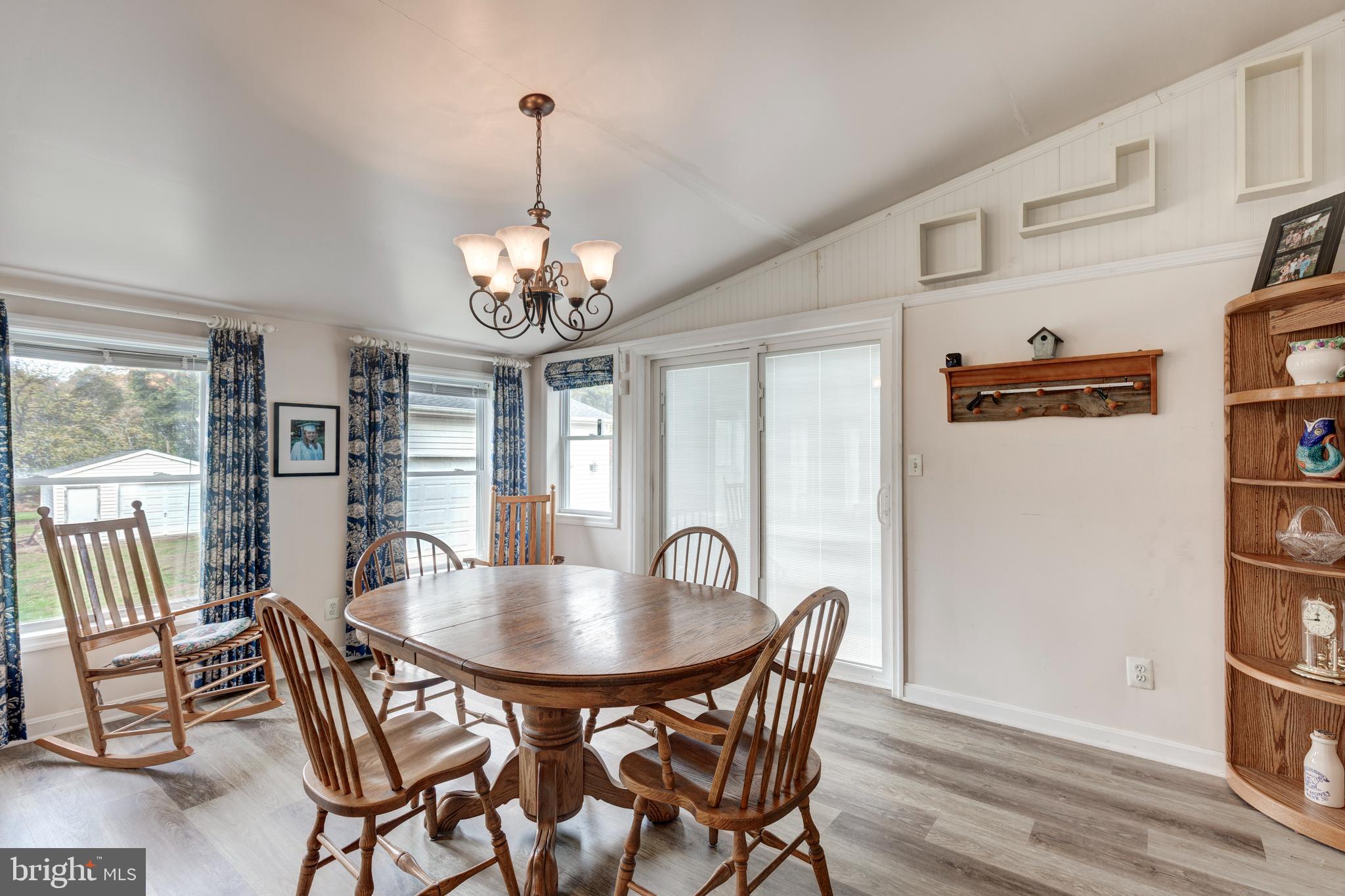 3402 Offutt Road Randallstown, MD 21133 - Photo 14 of 63 a dining room with furniture a chandelier and wooden floor