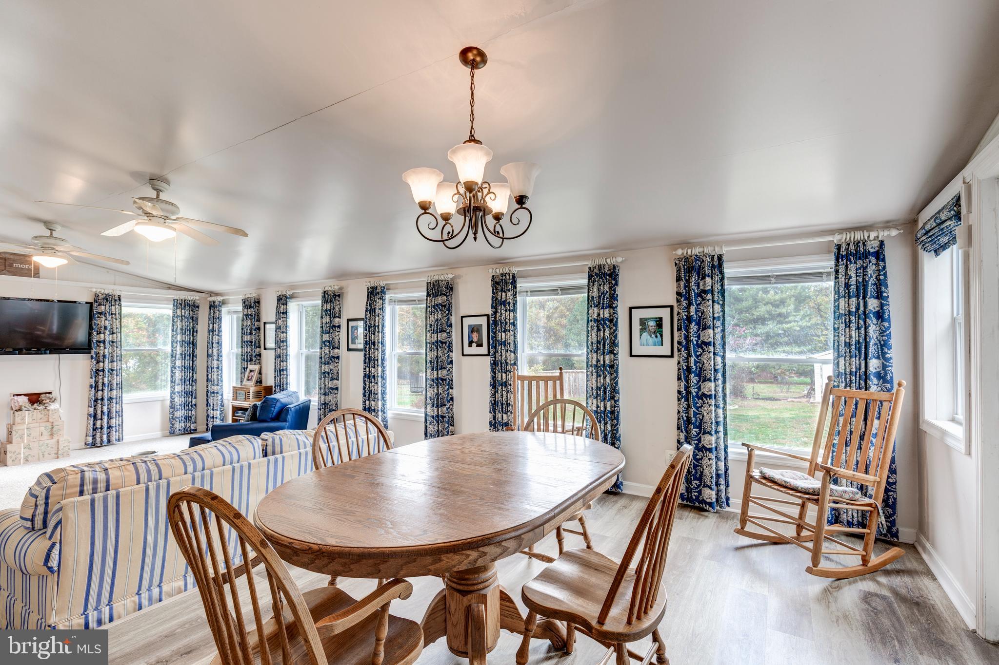 3402 Offutt Road Randallstown, MD 21133 - Photo 15 of 63 a view of a dining room with furniture wooden floor and chandelier