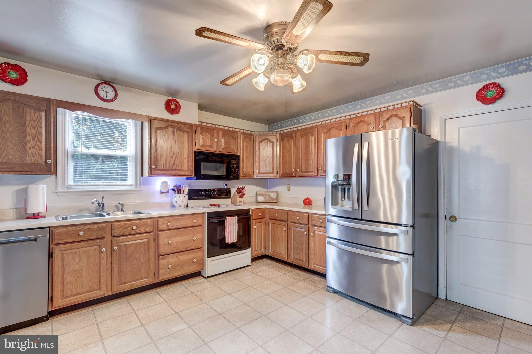 3402 Offutt Road Randallstown, MD 21133 - Photo 17 of 63 a kitchen with stainless steel appliances granite countertop a refrigerator and a sink