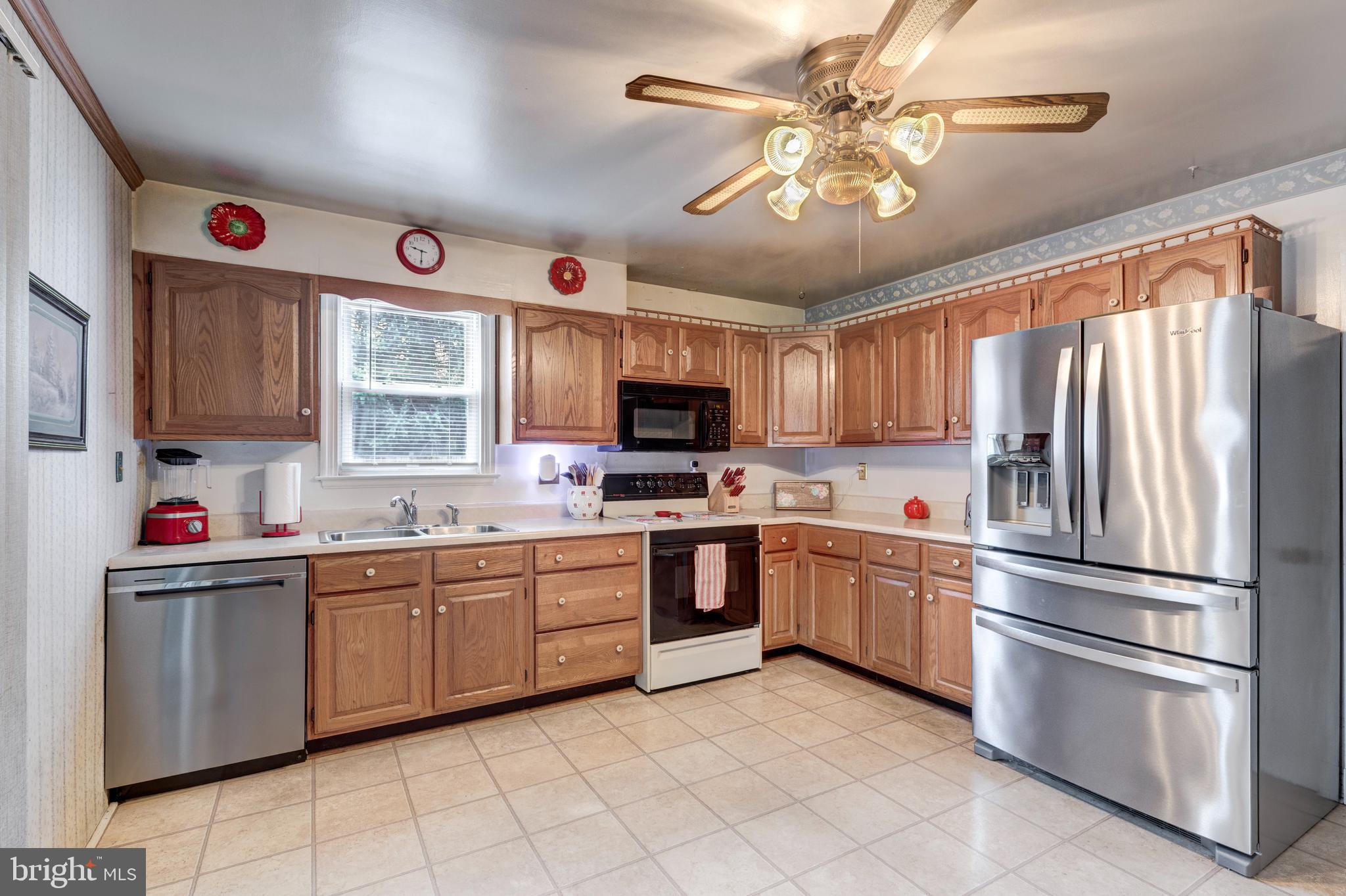 3402 Offutt Road Randallstown, MD 21133 - Photo 18 of 63 a kitchen with stainless steel appliances granite countertop a refrigerator and a sink