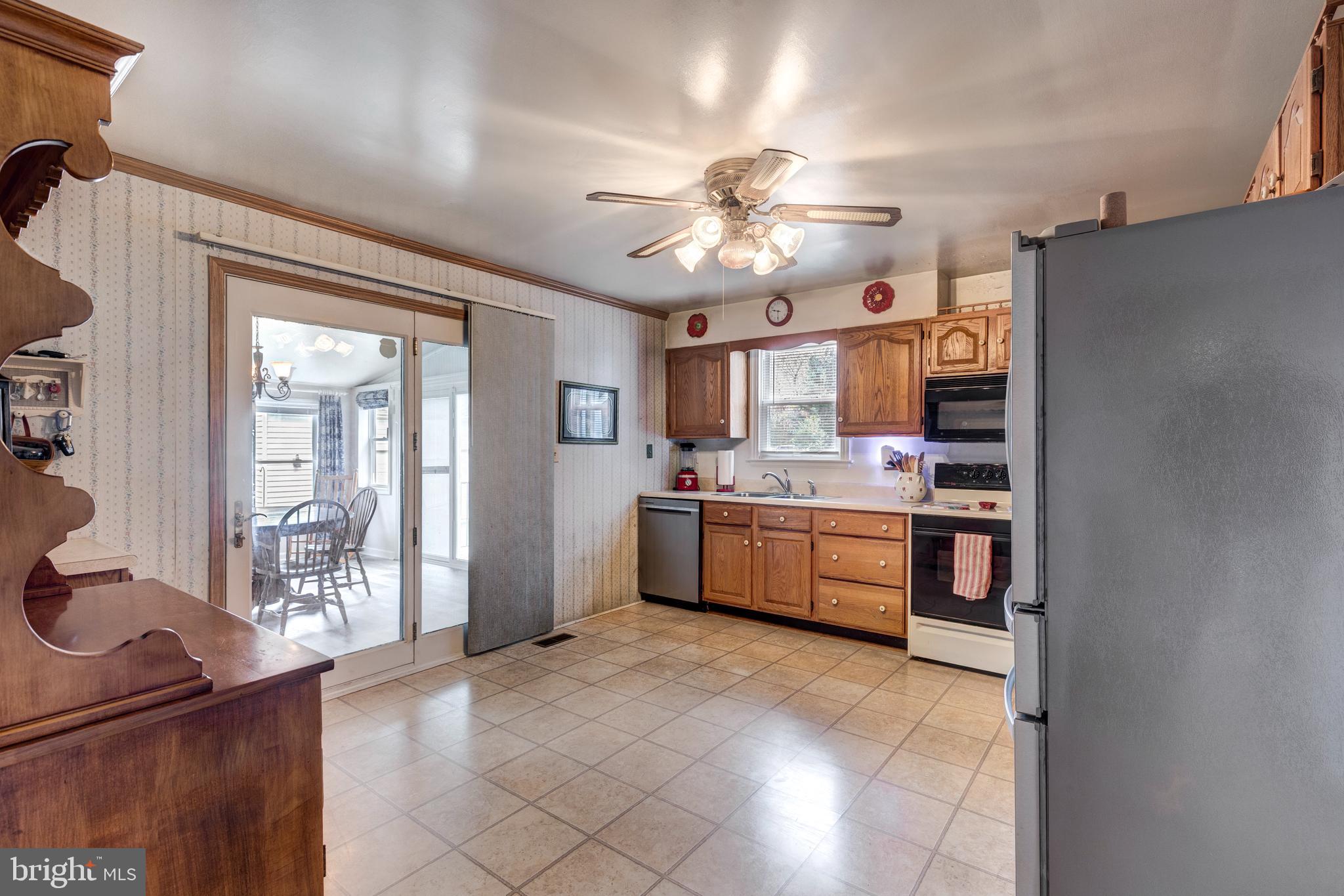 3402 Offutt Road Randallstown, MD 21133 - Photo 19 of 63 a large kitchen with a large counter top space a sink stainless steel appliances and cabinets