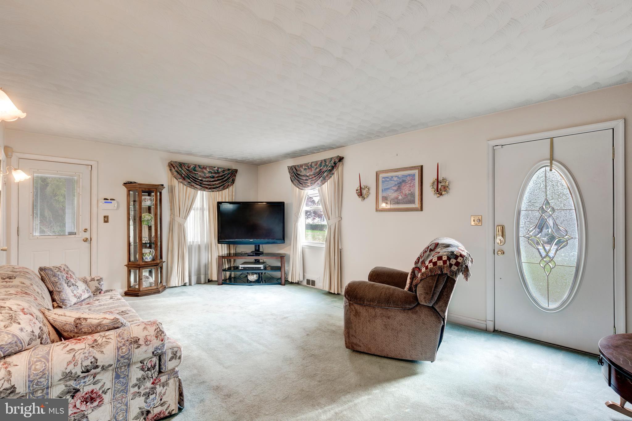 3402 Offutt Road Randallstown, MD 21133 - Photo 23 of 63 a living room with furniture a flat screen tv and a window