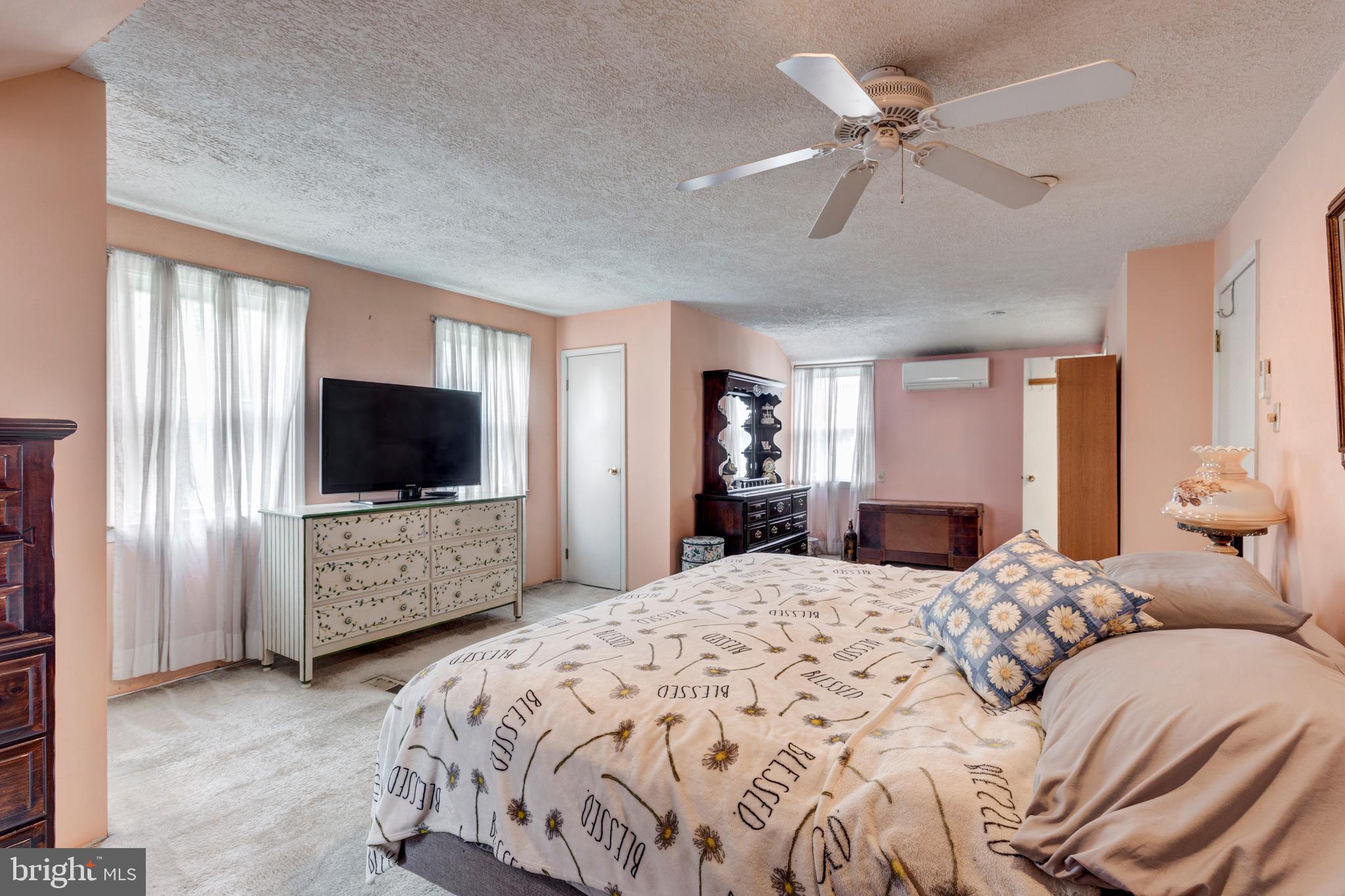 3402 Offutt Road Randallstown, MD 21133 - Photo 28 of 63 a bedroom with a large bed and a flat screen tv